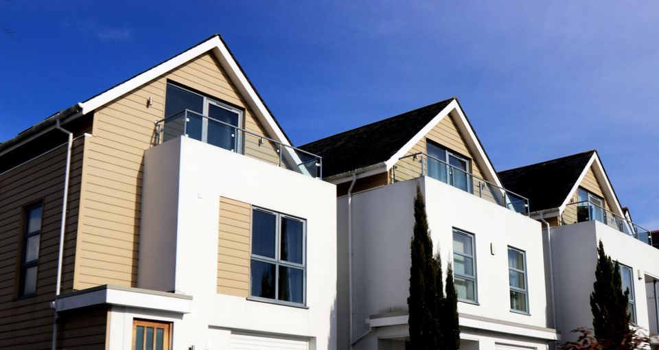 Homes with pitched shingle roofs